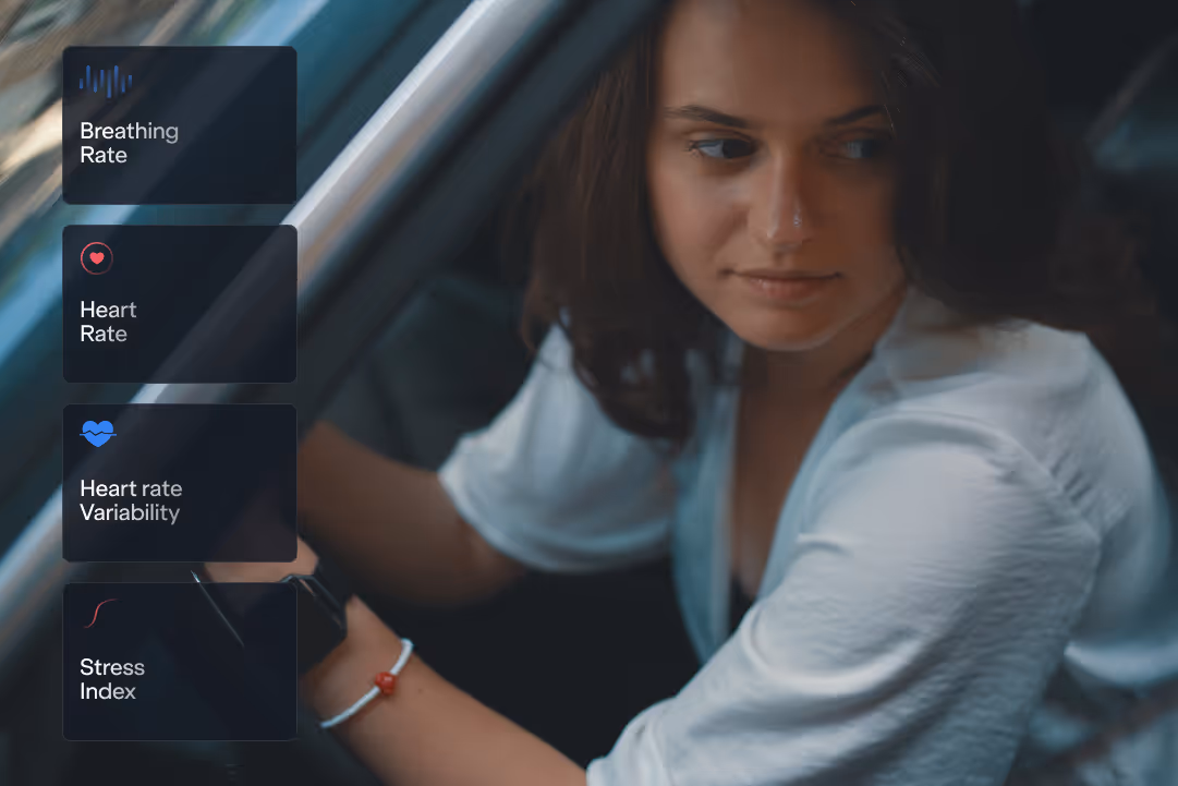 Woman in a white blouse sitting in a car, looking to her right, with overlays showing biometric monitoring: Breathing Rate, Heart Rate, Heart rate Variability, and Stress Index.